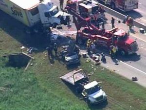 Overhead view of a major truck accident and a clean up crew.