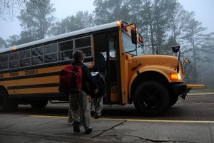 Children getting on a school bus