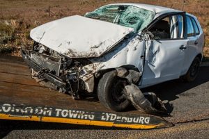 Damage on white sedan after head on collision