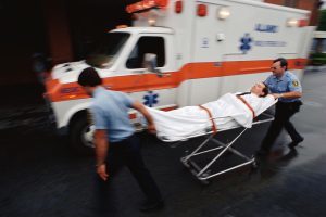 EMTs handling a person on a stretcher